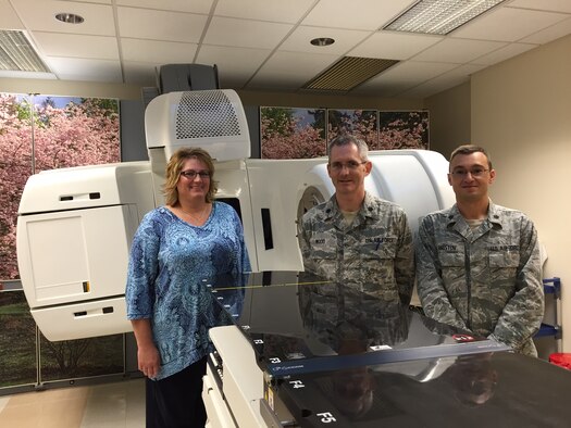 Michele Beck, (left) certified tumor registrar and tumor registry consultant, 88th Diagnostics and Therapeutics Squadron; Lt. Col. (Dr.) Roger Wood, director of the Wright-Patterson Medical Center Cancer Care Center and chair of the facility’s cancer committee; and Lt. Col. (Dr.) Borislav Hristov, chief, Radiation Oncology Clinic and Tumor Board chairman, stand in front of the center’s Trilogy Silhouette Linear Accelerator. The WPMC cancer care program has received full reaccreditation status with commendation for three years from the Commission on Cancer of the American College of Surgeons. 
