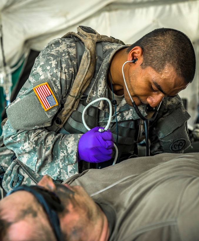 Army Spc. Muhammad Alam checks a simulated casualty’s blood pressure during a mass casualty exercise at the Joint Readiness Training Center, Fort Polk, La., July 16, 2016. Alam is assigned to the New York Army National Guard's Headquarters Company, 1st Battalion 69th Infantry. Army National Guard photo by Sgt. Harley Jelis
