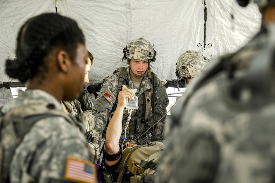 Army 1st Lt. Mercy Ukpe, left, instructs soldiers on treating a simulated casualty during a mass casualty exercise at the Joint Readiness Training Center, Fort Polk, La., July 16, 2016. Ukpe is assigned to the New York Army National Guard's Headquarters Company, 1st Battalion 69th Infantry. Army National Guard photo by Sgt. Harley Jelis