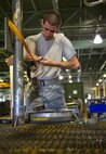 Airman 1st Class Michael Kearns, 5th Maintenance Squadron aerospace ground equipment apprentice, works on a rack at Minot Air Force Base, N.D., July 20, 2016. The racks are used to hold B-52H Stratofortress engine covers on the flight line. (U.S. Air Force photo/Senior Airman Apryl Hall)