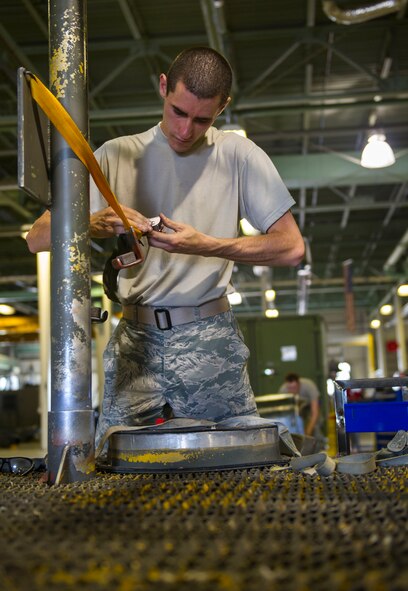 Airman 1st Class Michael Kearns, 5th Maintenance Squadron aerospace ground equipment apprentice, works on a rack at Minot Air Force Base, N.D., July 20, 2016. The racks are used to hold B-52H Stratofortress engine covers on the flight line. (U.S. Air Force photo/Senior Airman Apryl Hall)