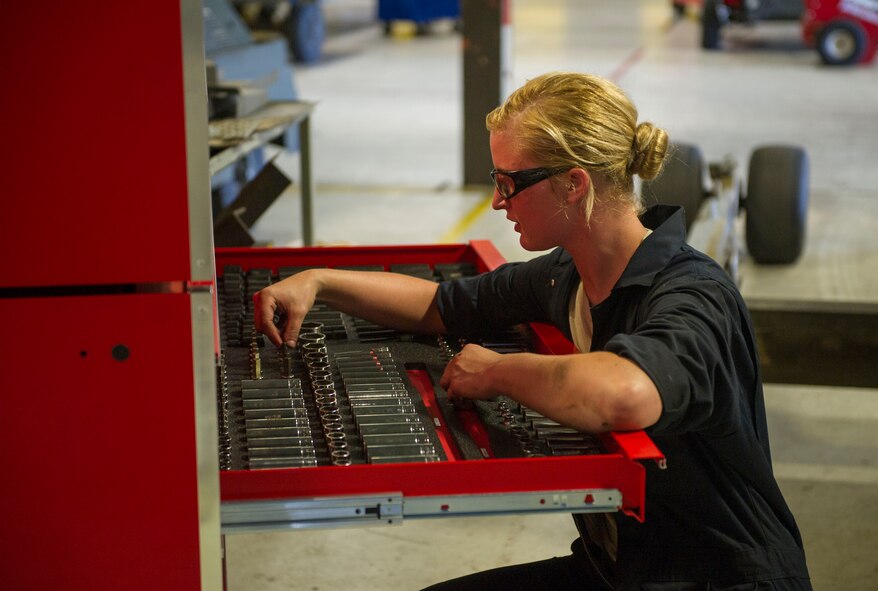 Airman 1st Class Michaela Lehman, 5th Maintenance Squadron aerospace ground equipment apprentice, grabs a tool at Minot Air Force Base, N.D., July 20, 2016. AGE specialists maintain and repair equipment that supplies electricity, hydraulic pressure and air pressure to B-52H Stratofortresses at Minot AFB. (U.S. Air Force photo/Senior Airman Apryl Hall)