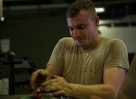 An aerospace ground equipment Airman from the 5th Maintenance Squadron works on a piece of equipment at Minot Air Force Base, N.D., July 20, 2016. AGE specialists maintain and repair equipment that supplies electricity, hydraulic pressure and air pressure to B-52H Stratofortresses at Minot AFB. (U.S. Air Force photo/Senior Airman Apryl Hall)