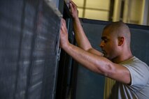 Airman 1st Class Jeremy Hudson, 5th Maintenance Squadron aerospace ground equipment journeyman, works on an air conditioning unit at Minot Air Force Base, N.D., July 20, 2016. AGE specialists are responsible for maintaining equipment used for aircraft maintenance. (U.S. Air Force photo/Senior Airman Apryl Hall)