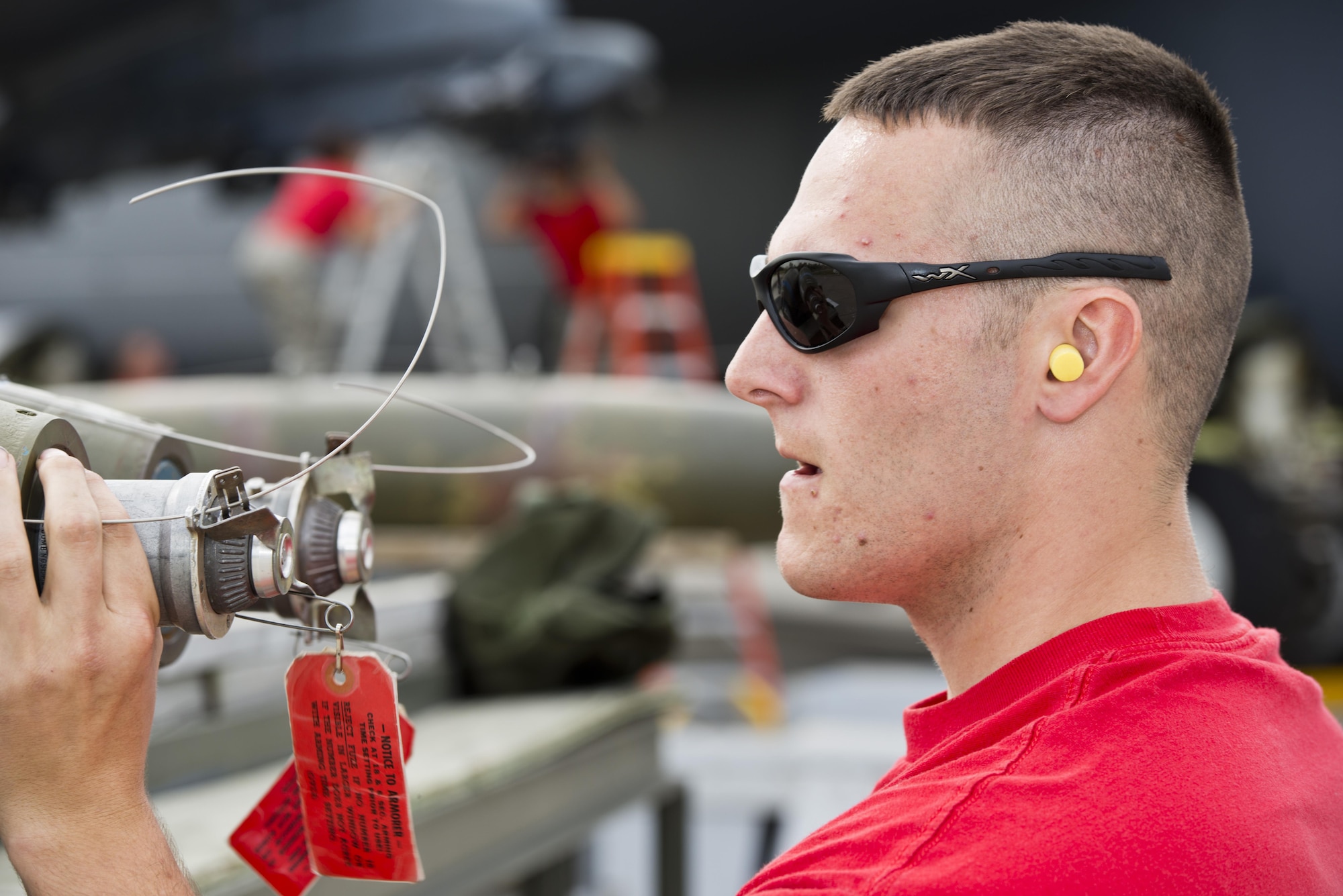 An Airmen from the 23rd Aircraft Maintenance Unit inspects an inert munition during the Load Crew of the Quarter competition at Dock 7 at Minot Air Force Base, N.D., July 22, 2016. Two weapons load crews, representing the 23rdand 69th Bomb Squadrons, were timed on their ability to load three inert munitions onto a B-52H Stratofortress. (U.S. Air Force photo/Airman 1st Class J.T. Armstrong)