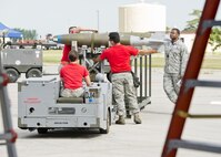 The 23rd Aircraft Maintenance Unit load crew use a MHU-83 “Jammer” to move an inert munition during the Load Crew of the Quarter competition at Dock 7 at Minot Air Force Base, N.D., July 22, 2016. Two weapons load crews, representing the 23rd and 69th Bomb Squadrons, were timed on their ability to load three inert munitions onto a B-52H Stratofortress. (U.S. Air Force photo/Airman 1st Class J.T. Armstrong)