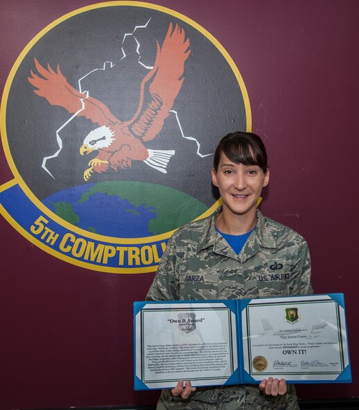 Tech. Sgt. Janene Garza, 5th Comptroller Squadron budget analyst, poses with her “Own It” award at Minot Air Force Base, N.D., July 22, 2016. Garza devoted over 200 hours assisting with the resource advisor duties while balancing her own responsibilities as the budget analyst for four other wing agencies. (U.S. Air Force photo/Airman 1st Class Christian Sullivan)