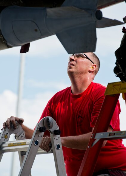 An Airmen from the 23rd Aircraft Maintenance Unit inspects an inert munition during the Load Crew of the Quarter competition at Dock 7 at Minot Air Force Base, N.D., July 22, 2016. The competition was comprised of four parts: dress and appearance, a loader’s knowledge test, toolbox inspection and the timed bomb load. (U.S. Air Force photo/Airman 1st Class J.T. Armstrong)