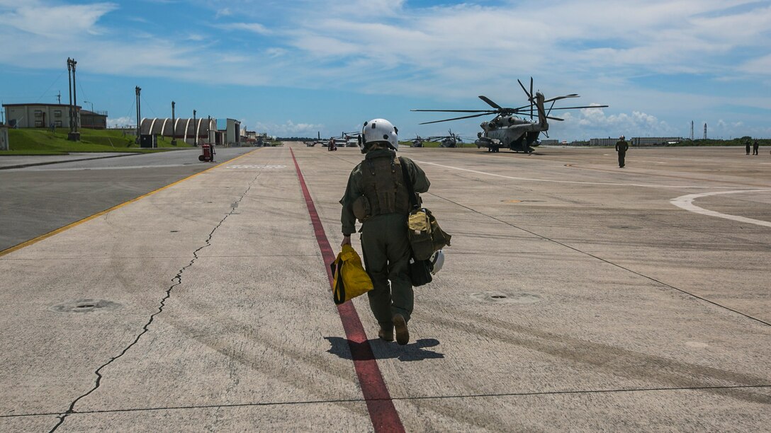 1st Lt. Molly Hurt approaches a CH-53E Super Stallion, Okinawa, Japan Marines with Marine Heavy Helicopter Squadron 361, 3rd Marine Aircraft Wing currently deployed with 1st Marine Aircraft Wing as part of the unit deployment program, worked alongside the Japan Self-Defense Force and Okinawa emergency services in Chura-Shima Rescue 2016. The annual exercise hosted by the 15th Brigade, Western Army, Japan Ground Self-Defense Force, trains humanitarian assistance and disaster relief-involved agencies for a swift reaction to a large-scale earthquake and tsunami in Okinawa. Hurt is a CH-53E pilot wit Marines with Marine Heavy Helicopter Squadron 361, 3rd Marine Aircraft Wing currently deployed with 1st Marine Aircraft Wing as part of the unit deployment program.