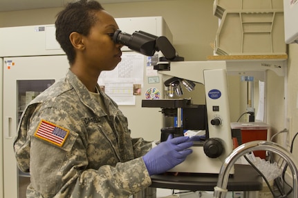 LOWER BRULE RESERVATION– U.S. Army Reserve Sgt. Zahra Campbell, a medical laboratory technician from Tuskegee, Ala., inspects a urine sample for contaminants July 19, 2016. Campbell is conducting an Innovative Readiness Training Mission at the Lower Brule Indian Health Center, a small clinic located in Lower Brule, S.D., with the 1207th U.S. Army Hospital. The Indian Reservation is 60 miles southeast of the state capital in Pierre. IRT allows Campbell, who is also a laboratory technician in her civilian capacity, to use her Army training, along with her civilian skills, to assist the Lower Brule IHC with clinical laboratory work. (U.S. Army Reserve photo by Spc. Rachel Skowyra) 