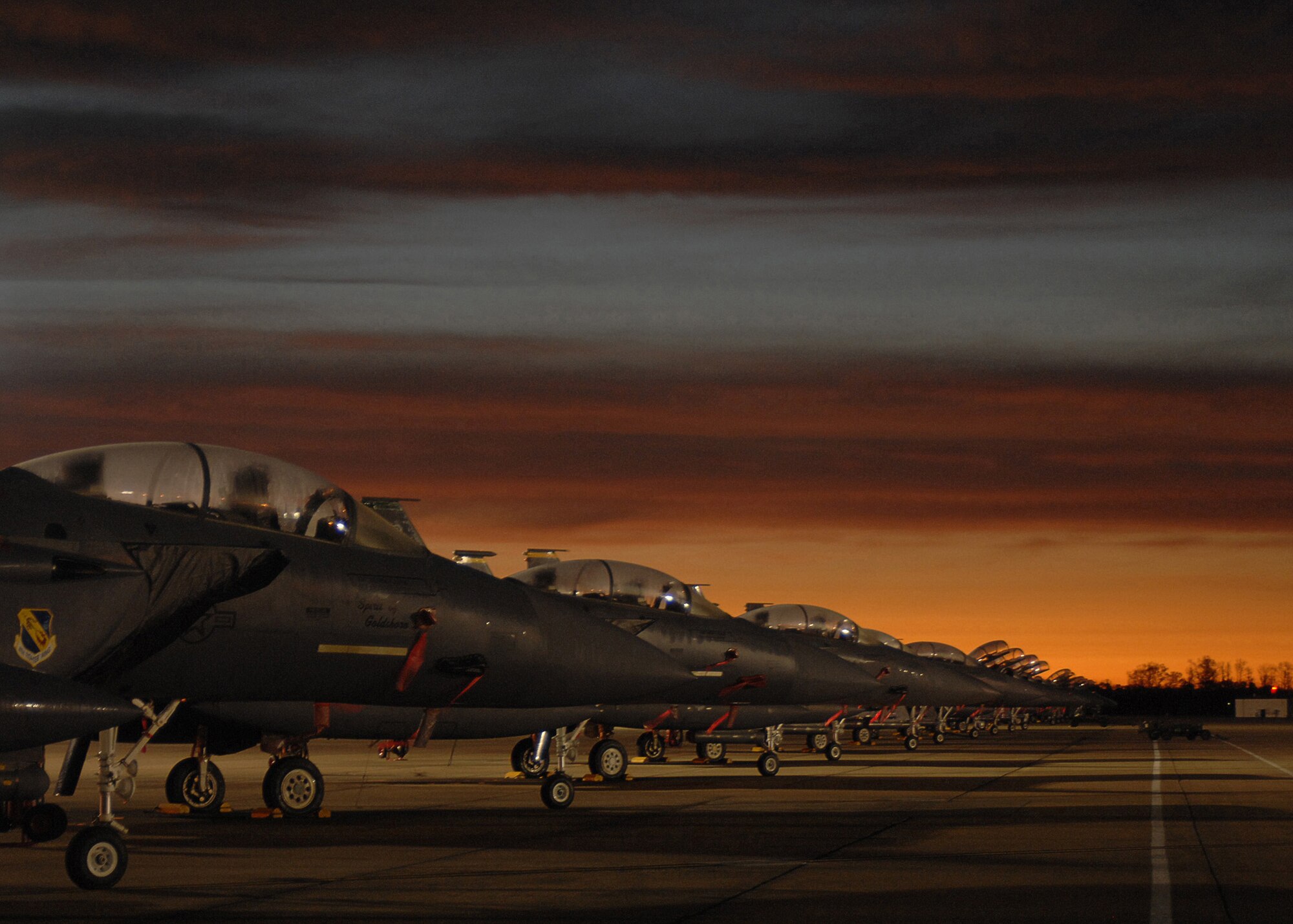 A row of F-15E Strike Eagles from the 4th Fighter Wing sit on the flightline of Seymour Johnson Air Force Base, North Carolina, January 9, 2008. The F-15E Strike Eagle is a dual-role fighter designed to perform air-to-air and air-to-ground missions.(U.S. Air Force photo by Senior Airman Greg C. Biondo) 