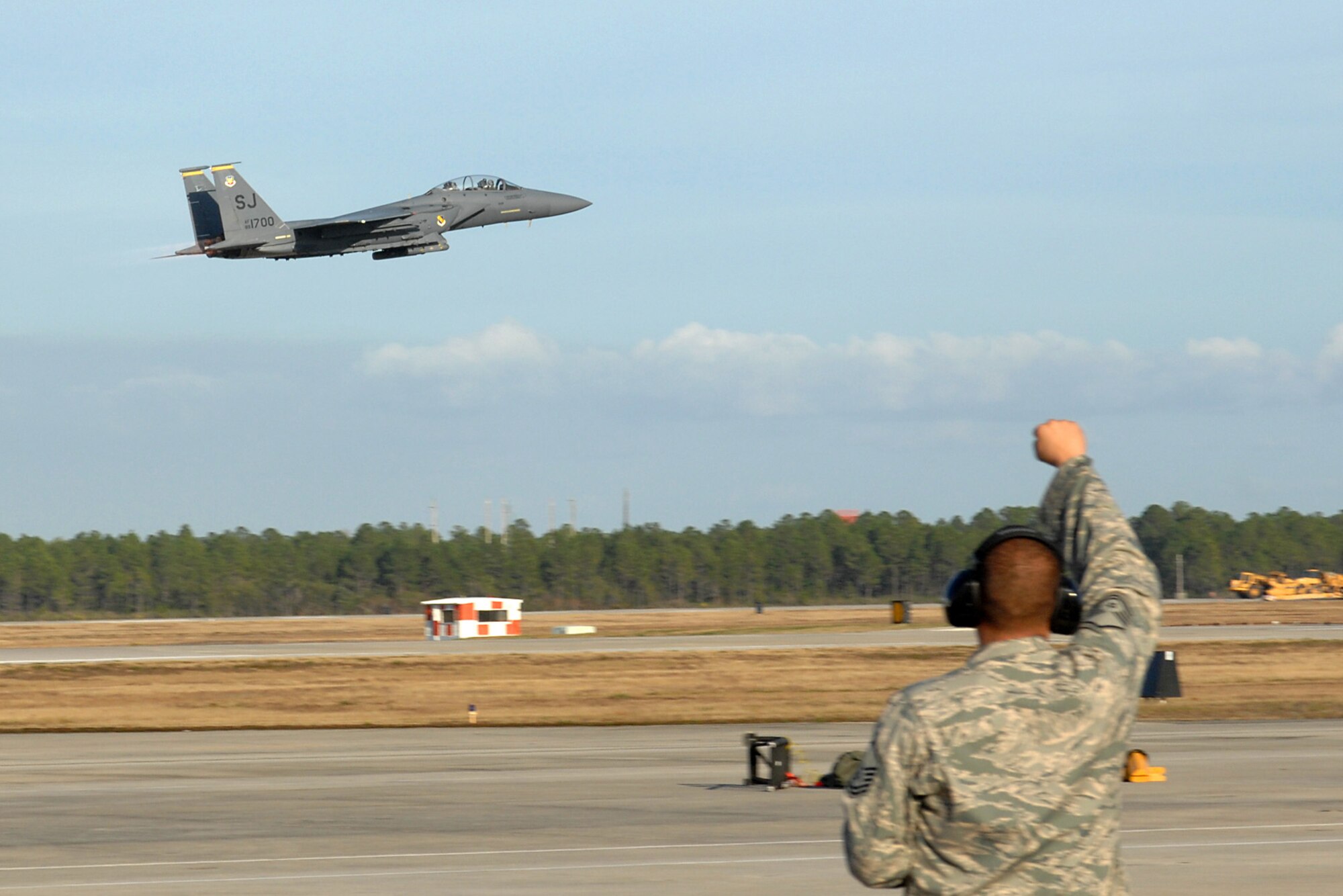 Master Sgt. Nathan Smith, 336th Aircraft Maintenance Unit, pumps a fist in the air while watching Senior Master Sgt. Mitchell Smith, 4th Aircraft Maintenance Squadron first sergeant, take off on an incentive flight in an F-15E Strike Eagle at Tyndall Air Force Base, Florida, Dec. 18. The 336th Fighter Squadron and associated maintenance personnel completed the two-week air-to-air combat evaluation known as Combat Archer Dec. 19. (U.S. Air Force photo by Staff Sgt. Shawn J. Jones)