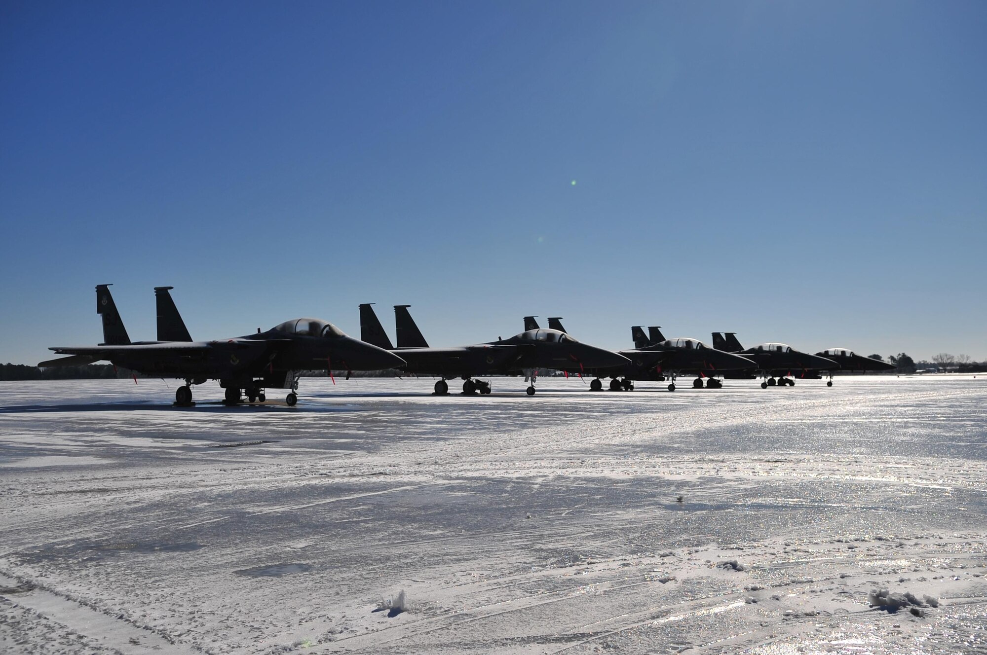 Five F-15E Strike Eagles sit on the frozen transient alert ramp at Seymour Johnson Air Force Base, N.C. Jan. 31, 2010. Snow plows and salt trucks were not used because Airfield Management and the 4th Logistics Readiness Squadron commander wanted to see if the snow and ice would melt on its own. (U.S. Air Force photo/Senior Airman Rae Perry)