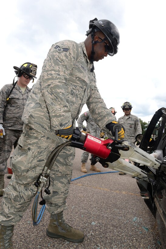 Air Force Senior Airman Reiginald Fairley practices using hydraulic tools during vehicle extrication training as part of Patriot North 16 at Volk Field, Wis., July 16, 2016. Fairley is a firefighter assigned to the Maryland Air National Guard’s 175th Civil Engineer Squadron. Air National Guard photo by Senior Master Sgt. David H. Lipp