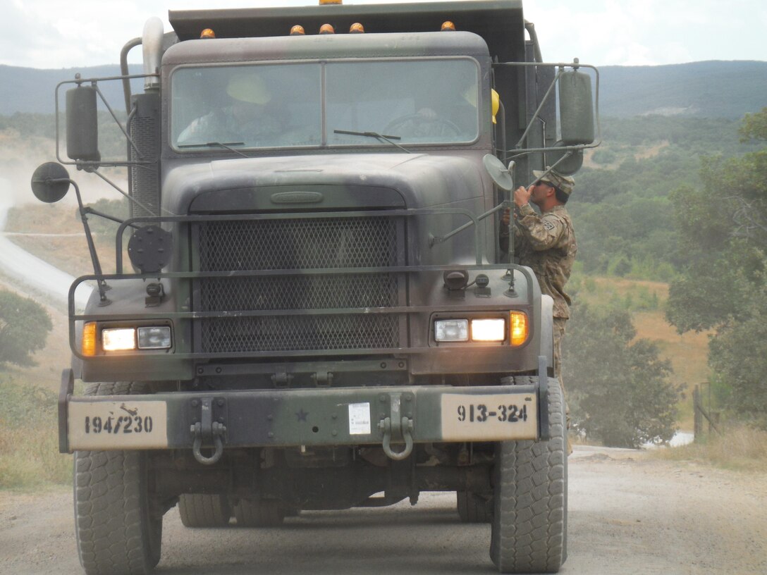 Army Reserve soldiers Pfc. Smith and Sgt. Fundora,  receive words of wisdom from Sgt. 1st Class Rosser of the 766th Engineer Company (Horizontal), 841st Engineer Battalion, U.S. Army Reserve, at Novo Selo Training Area, Bulgaria, while they work in their M917 20 Ton Dump Truck driven as part of Operation Resolute Castle 16, July 20, 2016. (U.S. Army photo by Capt. Jose F. Lopez Jr., 841st Eng. Bn., United States Army Reserve)