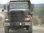 Army Reserve soldiers Pfc. Smith and Sgt. Fundora,  receive words of wisdom from Sgt. 1st Class Rosser of the 766th Engineer Company (Horizontal), 841st Engineer Battalion, U.S. Army Reserve, at Novo Selo Training Area, Bulgaria, while they work in their M917 20 Ton Dump Truck driven as part of Operation Resolute Castle 16, July 20, 2016. (U.S. Army photo by Capt. Jose F. Lopez Jr., 841st Eng. Bn., United States Army Reserve)