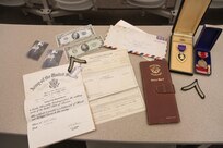 Donna Jones, planning director for Chenango County, reflects on her father's honorable discharge documents and Purple Heart medal received after his service in the Army during WWII.  Jones personal connection to the military is what inspired her to help bring the Innovative Readiness Training event to the Greater Chenango Cares area.  Greater Chenango Cares is one of the IRT events that provide real-world training in a joint civil-military environment while delivering world-class medical care to the people of Chenango County, N.Y., from July 15-24.
