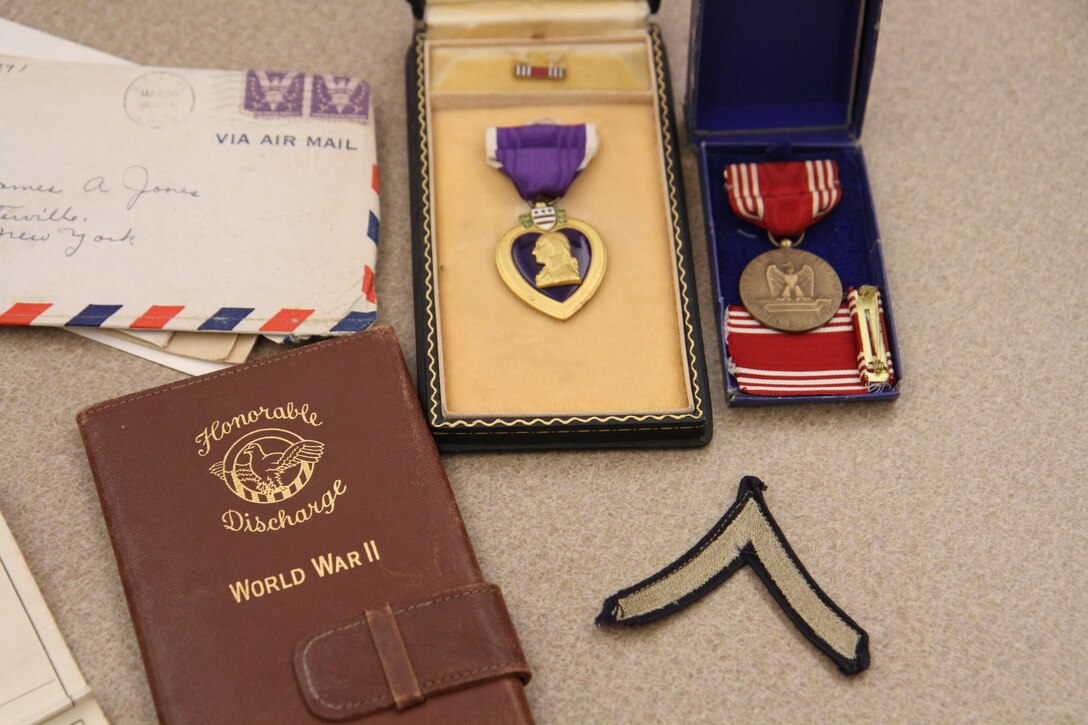 Donna Jones, planning director for Chenango County, reflects on her father's honorable discharge documents and Purple Heart medal received after his service in the Army during WWII.  Jones personal connection to the military is what inspired her to help bring the Innovative Readiness Training event to the Greater Chenango Cares area.  Greater Chenango Cares is one of the IRT events that provide real-world training in a joint civil-military environment while delivering world-class medical care to the people of Chenango County, N.Y., from July 15-24.