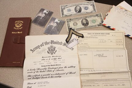 Donna Jones, planning director for Chenango County, reflects on her father's honorable discharge documents and Purple Heart medal received after his service in the Army during WWII.  Jones personal connection to the military is what inspired her to help bring the Innovative Readiness Training event to the Greater Chenango Cares area.  Greater Chenango Cares is one of the IRT events that provide real-world training in a joint civil-military environment while delivering world-class medical care to the people of Chenango County, N.Y., from July 15-24.