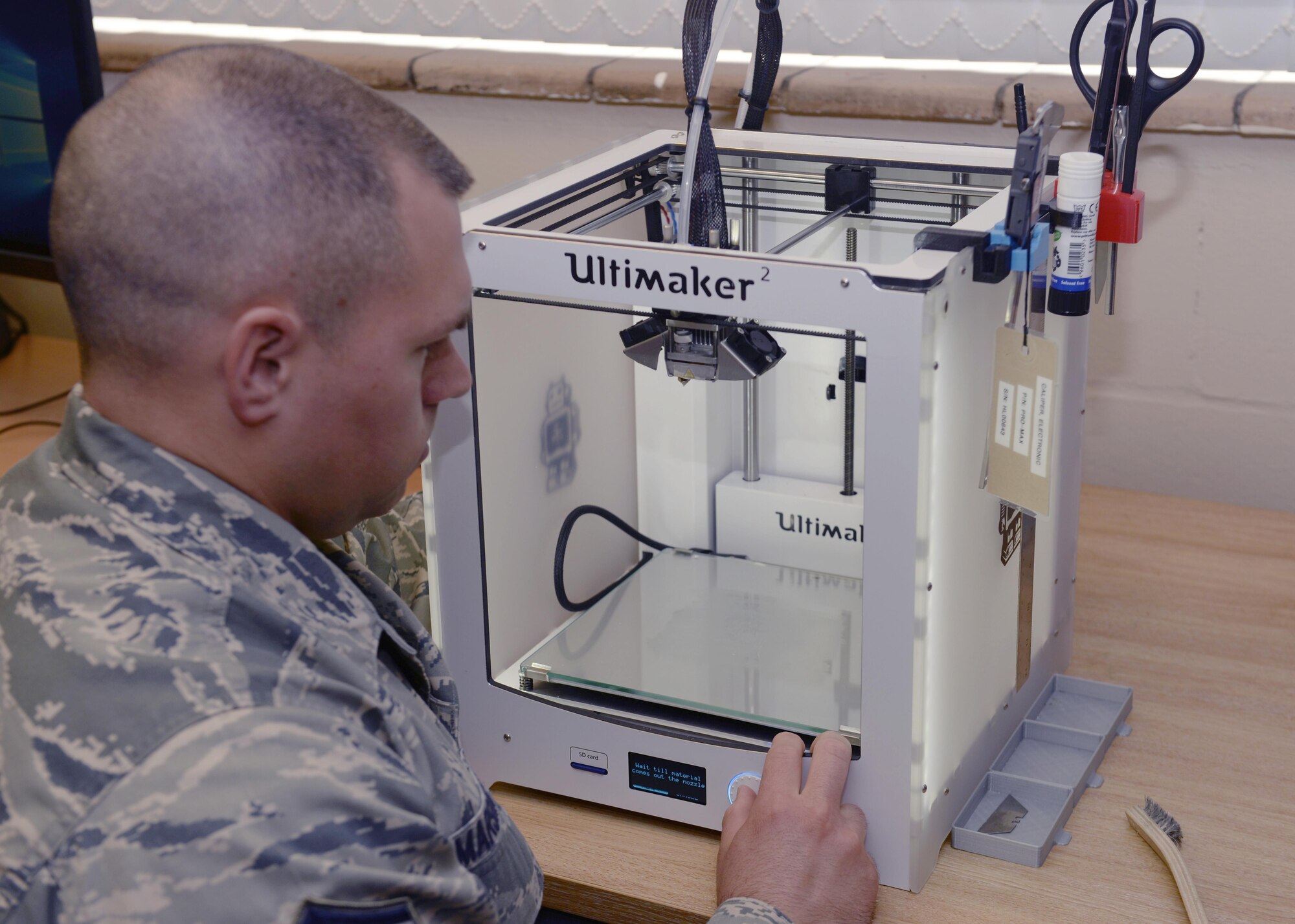 U.S. Air Force Master Sgt. David Marshall, 48th Maintenance Group Air Force Repair and Enhancement Program manager, prepares the 3-D printer to create a dental surgical guide at Royal Air Force Lakenheath, England, July 8. The printer creates 3-D objects by printing in 0.1 mm layers. (U.S. Air Force photo/Airman 1st Class Abby L. Finkel) 