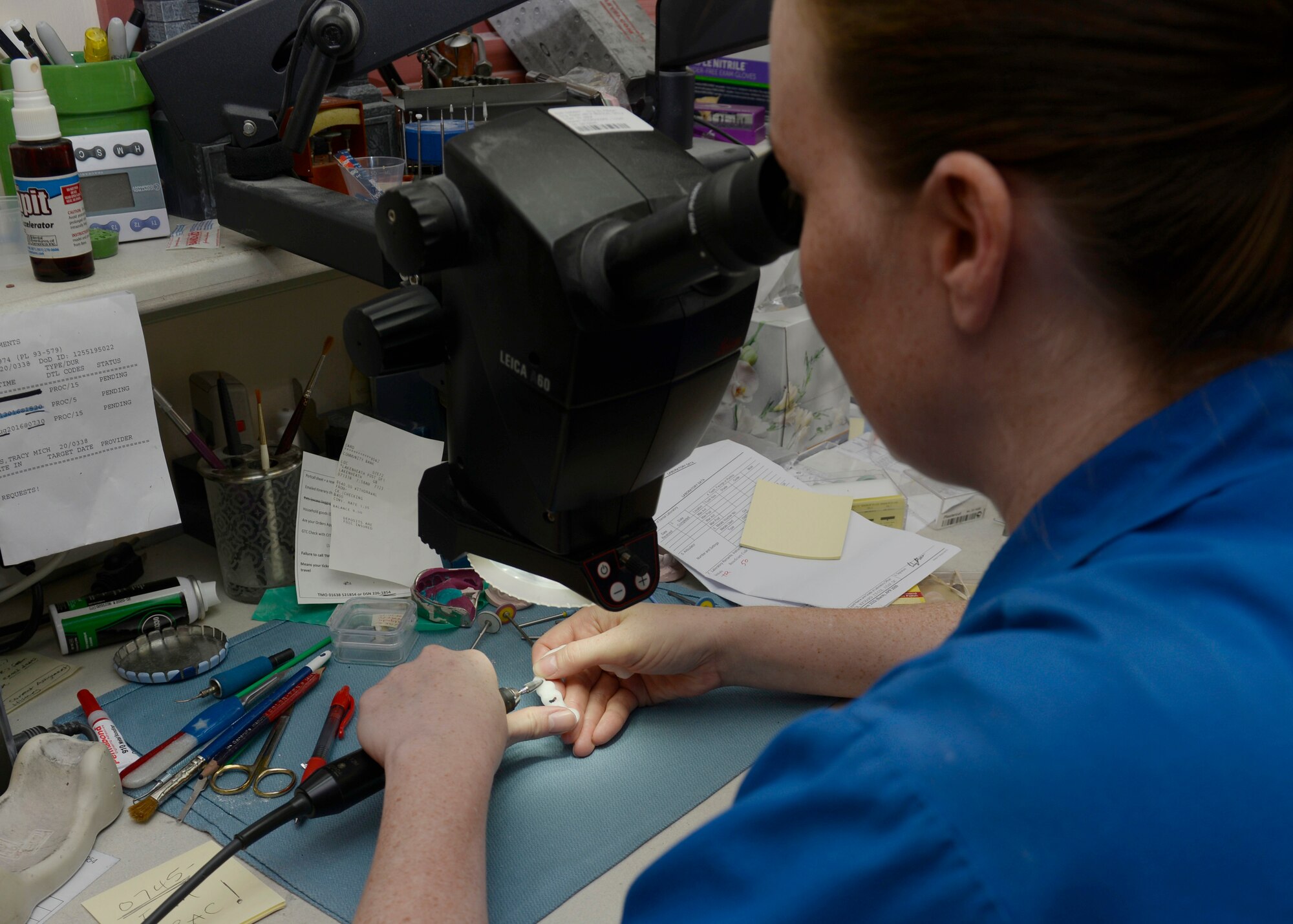 U.S. Air Force Tech. Sgt. Tracy Roberts, 48th Dental Squadron NCOIC, fixed element, works on a surgical dental guide at Royal Air Force Lakenheath, England, July 13. After receiving the guides, the dental lab smooths down any rough spots before use in surgery. (U.S. Air Force photo/Airman 1st Class Abby L. Finkel) 