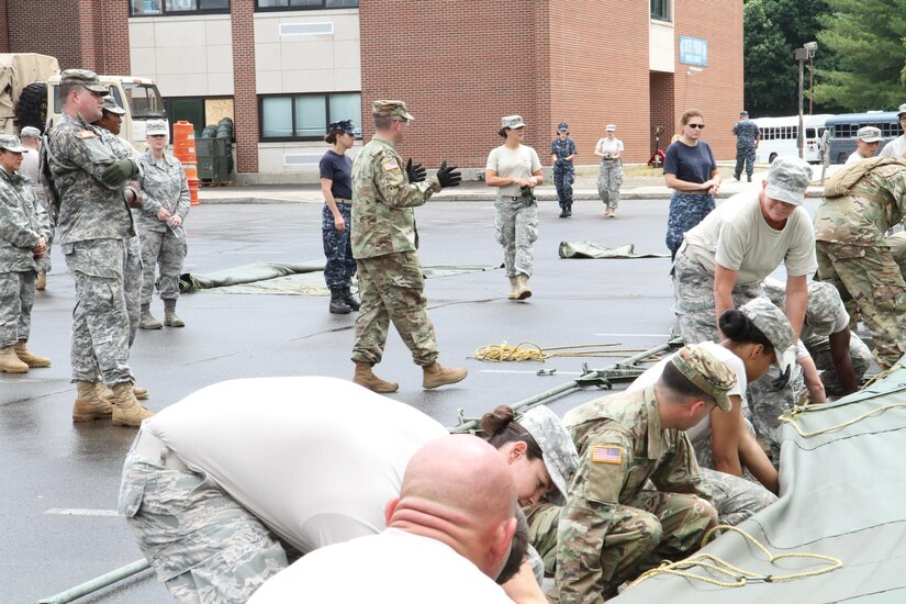 Capt. Burke Tervort, with the 48th Combat Support Hospital out of Fort Meade, Md., gives commands to service members in order to set up the veterinary hospital tents in preparation for the Healthy Cortland Innovative Readiness Training event, July 14th, 2016.  Healthy Cortland is one of the IRT events that provides real-world training in a joint civil-military environment while delivering world-class medical care to the people of Cortland County, N.Y., from July 15-24.
