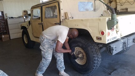 Spc. William Johnson, 650th Regional Support Group maintenance specialist, does maintenance on a Humvee tire, during drivers training, which included the use of the Virtual Clearance Training Suite system simulator, at the Taylor Hall U.S. Army Reserve Center in Las Vegas July 15. With this virtual training, Soldiers were guided step by step through the different levels of detection and identification so that they could neutralize explosive hazards. These methods and systems are the future of warfare on the battlefield.