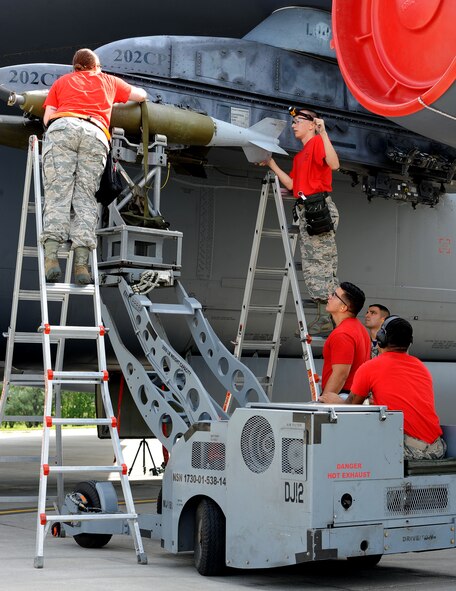 The 69th Aircraft Maintenance Unit load crew use a MHU-83 “Jammer” to move an inert munition during the Load Crew of the Quarter competition at Dock 7 at Minot Air Force Base, N.D., July 22, 2016. Two weapons load crews, representing the 23rd Bomb Squadron, were timed on their ability to load three inert munitions onto a B-52H Stratofortress. (U.S. Air Force photo/Senior Airman Kristoffer Kaubisch)