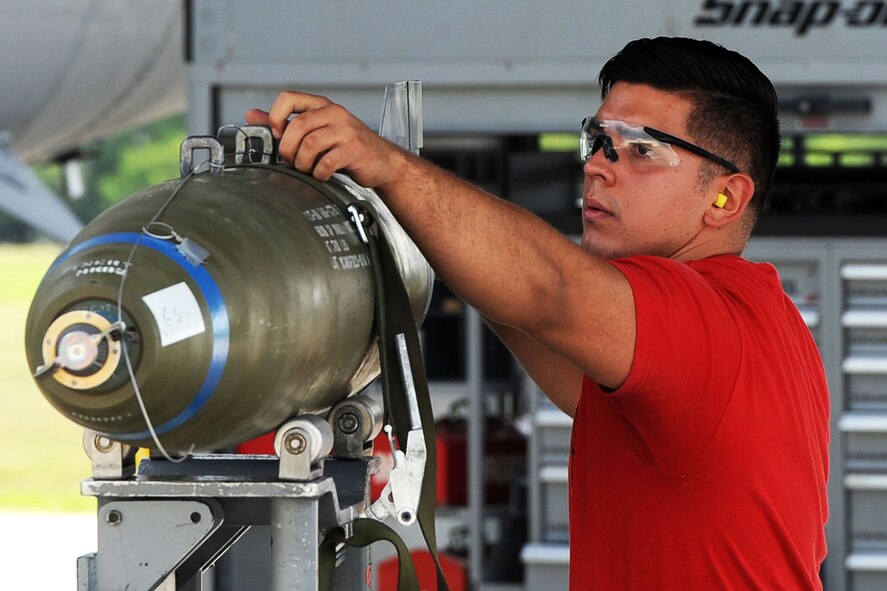 An Airmen from the 69th Aircraft Maintenance Unit inspects an inert munition during the Load Crew of the Quarter competition at Dock 7 at Minot Air Force Base, N.D., July 22, 2016. Two weapons load crews, representing the 23rd Bomb Squadron, were timed on their ability to load three inert munitions onto a B-52H Stratofortress. (U.S. Air Force photo/Senior Airman Kristoffer Kaubisch)