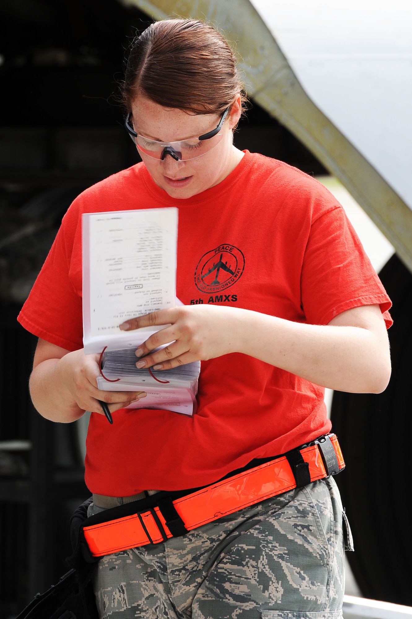 An Airmen from the 23rd Aircraft Maintenance Unit load crew goes over a checklist during the Load Crew of the Quarter competition at Dock 7 at Minot Air Force Base, N.D., July 22, 2016. The competition was comprised of four parts: dress and appearance, a loader’s knowledge test, toolbox inspection and the timed missile load. (U.S. Air Force photo/Senior Airman Kristoffer Kaubisch)
