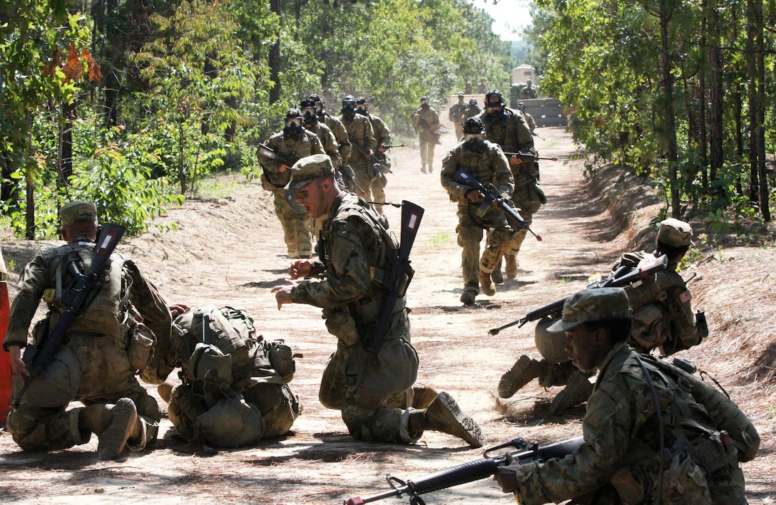 Basic Combat Training (BCT) Soldiers acting as their Command Post's (CP) Quick Reaction Force (QRF) run toward a simulated casualty being carried by members of his squad to provide protection as well as assist in his evacuation July 20, during their BCT Company's final field training exercise (FTX)  at Fort Jackson, S.C. before their graduation.  The final FTX allows the Soldiers to apply all of their training under the most rigorous and stressful conditions similar to real combat operations. (U.S. Army photo by Sgt. Javier Amador)