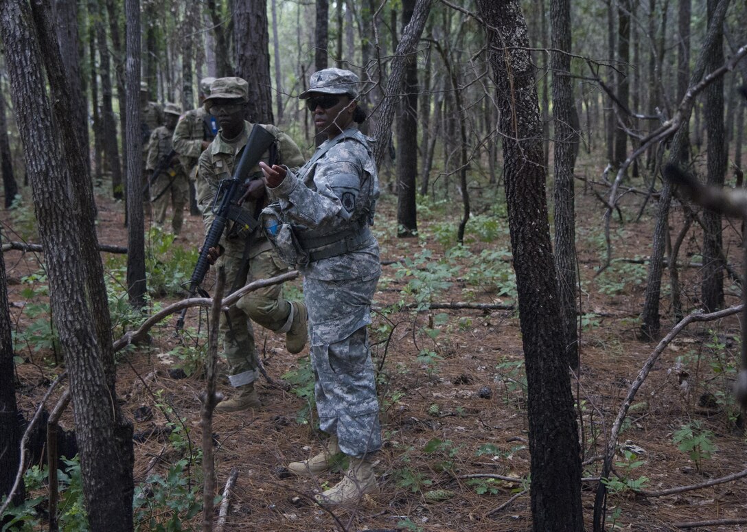 Army Reserve drill sergeant, Sgt. Leah Anderson of Company D, 518th  Battalion, 2nd Headquarters Brigade, 98th Training Division (Initial Entry Training) directs Basic Combat Training (BCT) Soldiers through rough terrain to ensure their safety July 20 during their BCT Company's final field training exercise (FTX) at Fort Jackson, S.C. before their graduation. The final FTX allows the Soldiers to apply all of their training under the most rigorous and stressful conditions similar to real combat operations. (U.S. Army photo by Sgt. Javier Amador) (released)