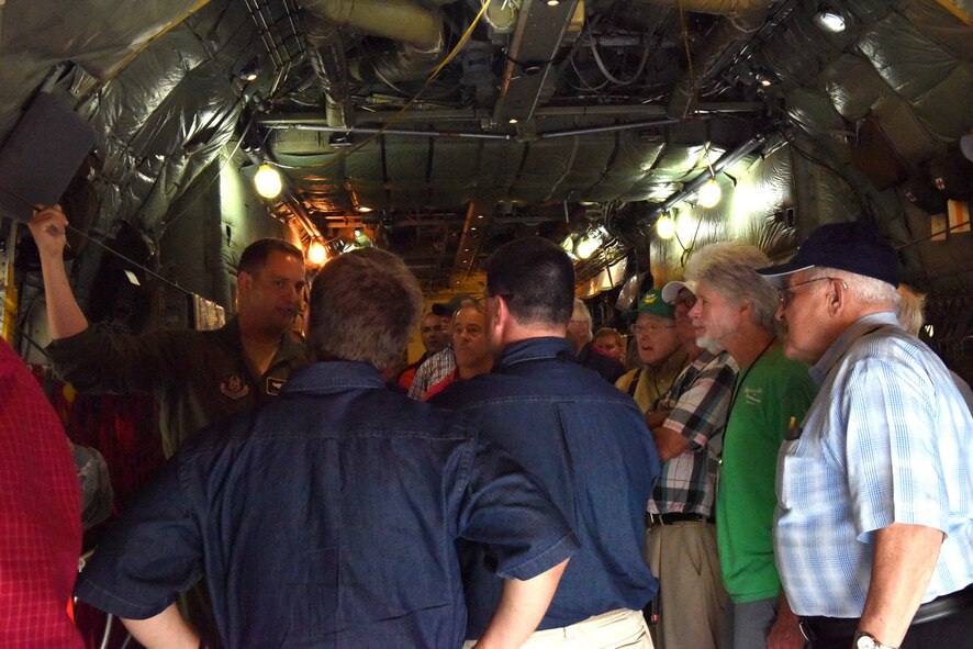 Capt. Charles Baker, chief of training with the 758th Airlift Squadron, guides members of the National Association of Priest Pilots on a tour of a C-130 Hercules at the Pittsburgh International Airport Air Reserve Station, July 13, 2016. The priest pilots learned about the C-130 Hercules aircraft and the specific issues faced by reservists. (U.S. Air Force courtesy photo by Ashley Podrasky)