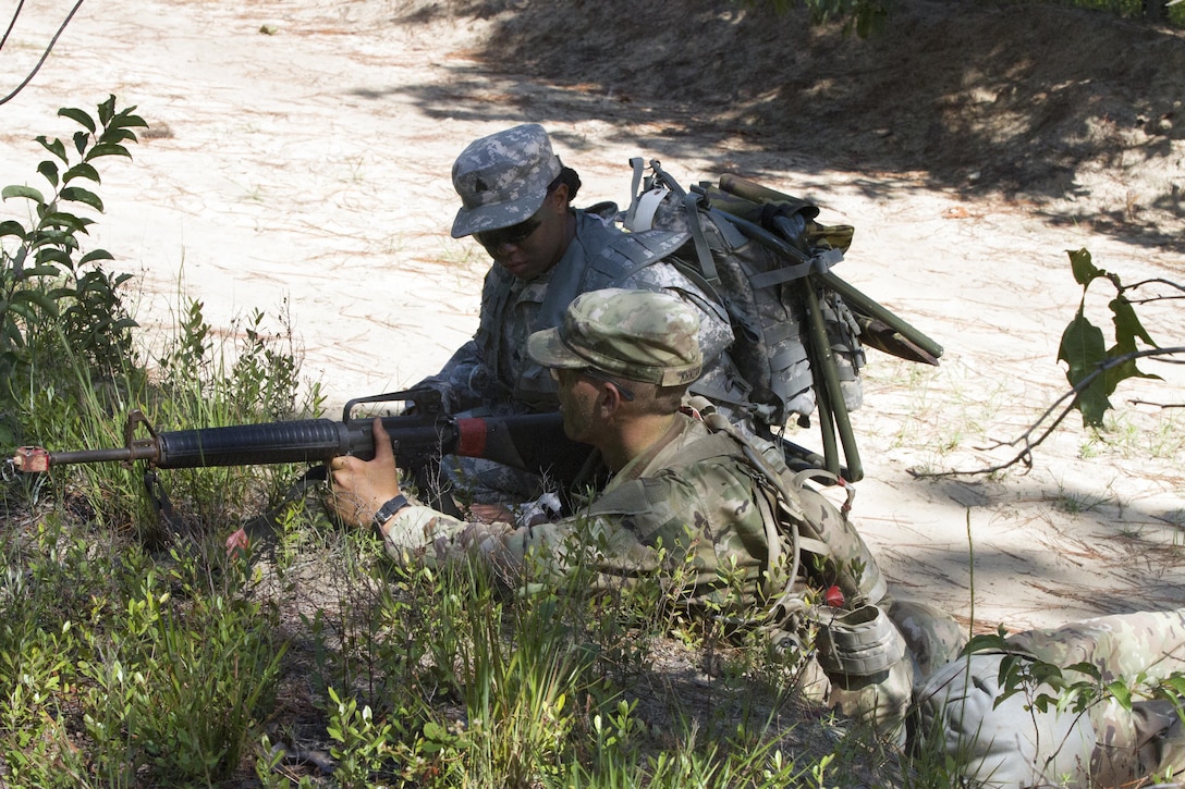 Army Reserve drill sergeant, Sgt. Leah Anderson of Company D, 518th  Battalion, 2nd Headquarters Brigade, 98th Training Division (Initial Entry Training) corrects a Basic Combat Training (BCT) Soldier on maintaining the proper weapon posture when providing defensive fire in reaction to an enemy attack July 20, during his BCT Company's final field training exercise (FTX) at Fort Jackson, S.C. before their graduation.  The final FTX allows the Soldiers to apply all of their training under the most rigorous and stressful conditions similar to real combat operations. (U.S. Army photo by Sgt. Javier Amador) (released)