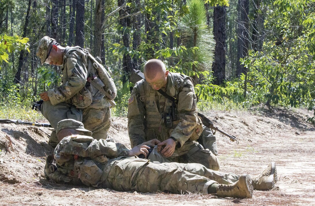 Basic Combat Training (BCT) Soldiers call in a Medical Evacuation (MEDEVAC) request for their simulated casualty July 20, during their BCT Company's final field training exercise (FTX)  at Fort Jackson, S.C. before their graduation.  The final FTX allows the Soldiers to apply all of their training under the most rigorous and stressful conditions similar to real combat operations. (U.S. Army photo by Sgt. Javier Amador)