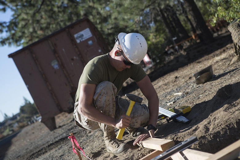 Lance Cpl. Dylan Hunt, a combat engineer with Engineer Services Company, Combat Logistics Battalion 23, Combat Logistics Regiment 4, 4th Marine Logistics Group, Marine Forces Reserve, helps prepare the foundation for an ATV storage shed during Exercise Forest Rattler in Bend, Ore., July 20, 2016. This opportunity to train with the U.S. Forest Service provides realistic, cost-effective training, and allows the Marine Corps to give back to the community.  (U.S. Marine Corps photo by Sgt. Sara Graham/ Released)