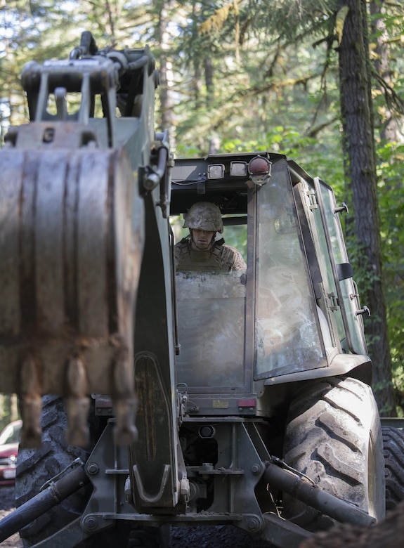 Lance Cpl. Nick Bean, a heavy equipment operator with Engineer Services Company, Combat Logistics Battalion 23, Combat Logistics Regiment 4, 4th Marine Logistics Group, Marine Forces Reserve, repairs culverts in roads running through the Willamette National Forest during Exercise Forest Rattler in Oakridge, Ore., July 21, 2016. The exercise not only allowed the Marines to give back to the community by repairing roads they utilize, but gave them time to hone their skills as an engineering service company. (U.S. Marine Corps photo by Sgt. Sara Graham/ Released)