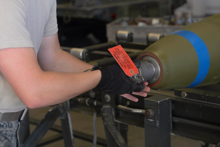 An Airman from the 5th Munitions Squadron installs a nose fuse on an MK-82 bomb at Minot Air Force Base, N.D., July 20, 2016. Airman have to ensure the timer is set to the proper setting and properly labeled before finalizing production.  (U.S. Air Force photo/Airman 1st Class Jessica Weissman)