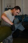Airman 1st Class Derek Merkley, a conventional munitions crew member assigned to the 5th Munitions Squadron, installs the fin to an inert bomb at Minot Air Force Base, N.D., July 20, 2016. These inert bombs were built for training purposes during the recent Load Crew of the Quarter competition. (U.S. Air Force photo/Airman 1st Class Jessica Weissman)