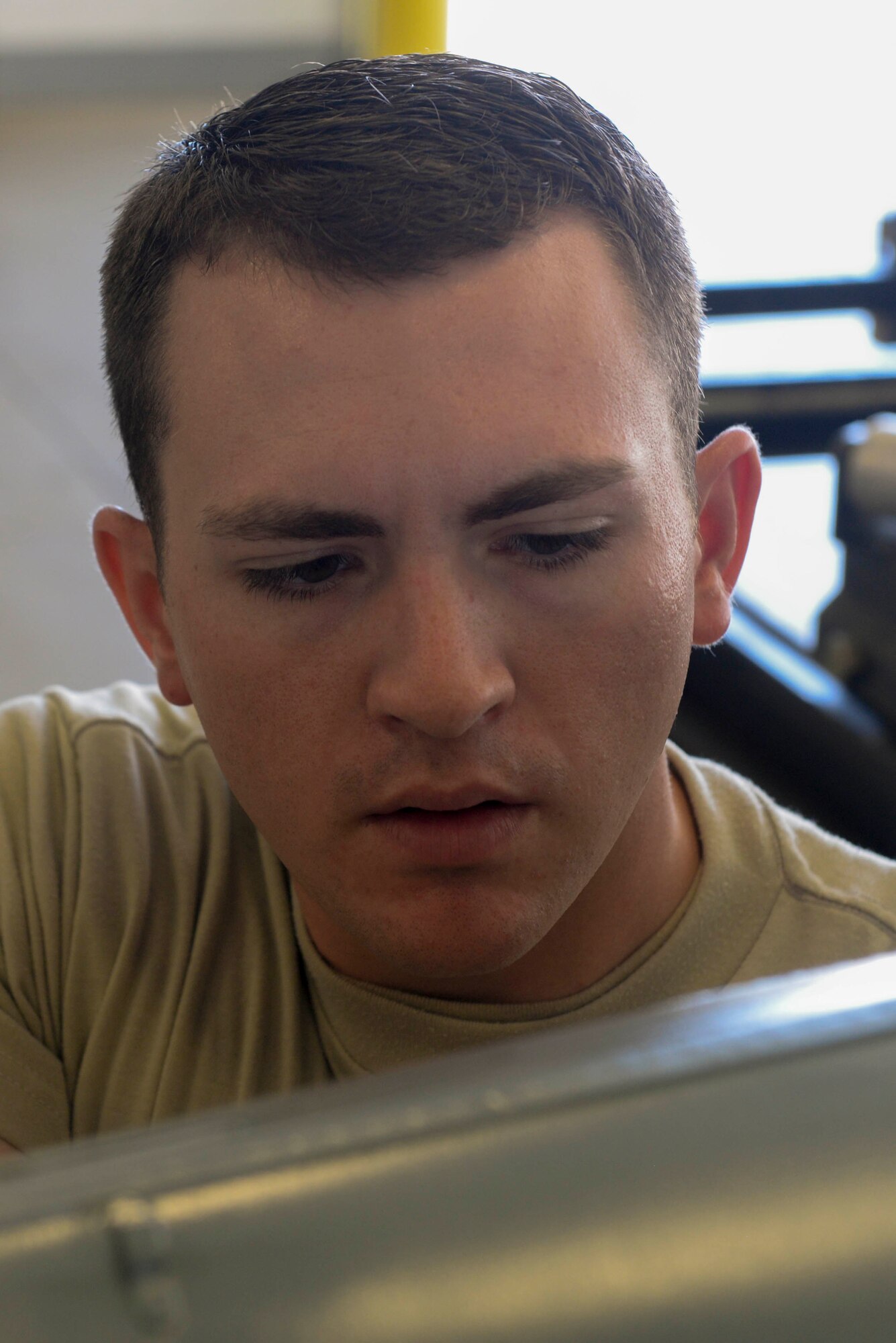 Airman 1st Class Derek Merkley, a conventional munitions crew member assigned to the 5th Munitions Squadron, installs a fuse drive unit to an inert bomb at Minot Air Force Base, N.D., July 20, 2016. Every bomb is built by hand and every component is inspected prior to any construction. (U.S. Air Force photo/Airman 1st Class Jessica Weissman)