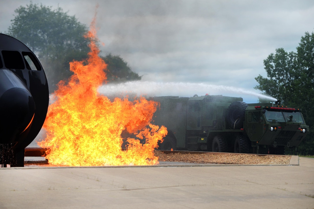 National guardsmen spray water from a firefighting truck’s turret to put out a fire during the Patriot North 16 exercise at Volk Field, Wis., July 17, 2016. Air National Guard photo by Senior Master Sgt. David H. Lipp