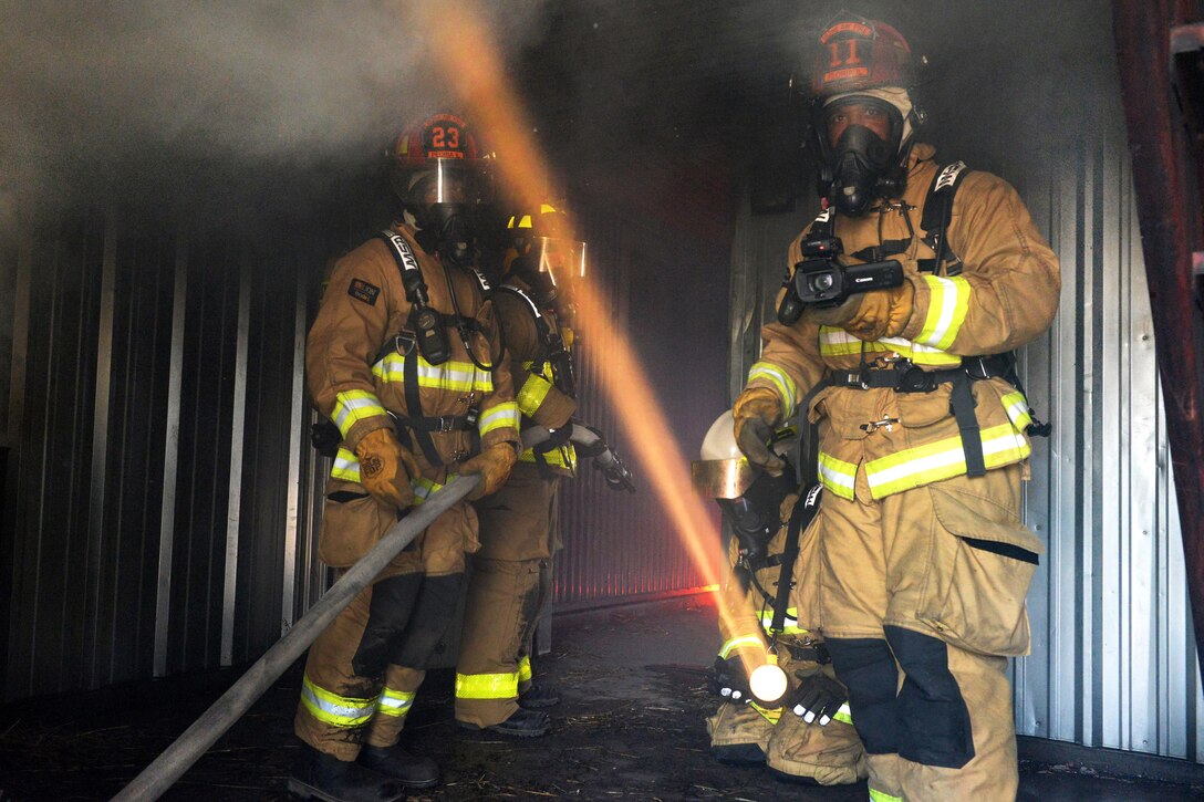 From left to right: Air Force Airman 1st Class Randle Taborn, Army Spc. Stephen Jensen, Air Force Tech. Sgt. Derrick Crawford, and Air Force Senior Airman Edgar Ewing prepare to exit a smoke-filled room while participating in a structural live-fire training during the Patriot North 16 exercise at Volk Field Air National Guard Base, Wis., July 17, 2016. Taborn and Ewing are firefighters assigned to the Illinois Air National Guard’s 182nd Civil Engineer Squadron. Jensen is a firefighter assigned to the 395th Ordnance Company. Crawford is a firefighter assigned to the West Virginia Air National Guard’s 167th Civil Engineer Squadron. Air National Guard photo by Senior Master Sgt. David H. Lipp