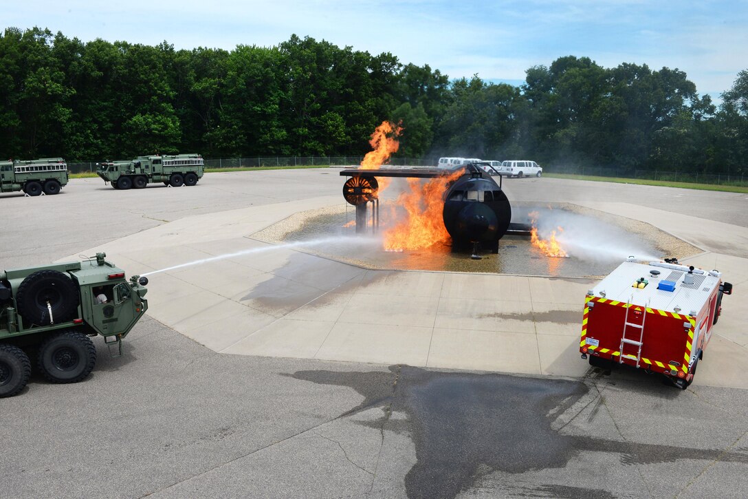 National Guard members spray water onto a mock aircraft fire during exercise Patriot North 16 at Volk Field, Wis., July 17, 2016. Air National Guard photo by Senior Master Sgt. David H. Lipp