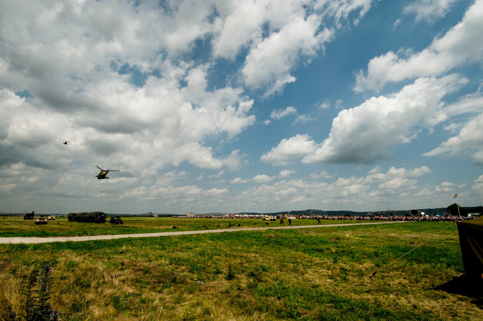 Romanian armed forces helicopters, soldiers, tanks and vehicles participate in a simulated combat and rescue scenario during the Romanian air force's 71st Air Base's air show and open house at Campia Turzii, Romania, July 23, 2016. The aviation demonstration took place during the middle of the U.S. Air Force's 194th Expeditionary Fighter Squadron's six-month long theater security package deployment to Europe in support of Operation Atlantic Resolve, which aims to bolster the U.S.'s continued commitment to the collective security of NATO and dedication to the enduring peace and stability in the region. The unit, comprised of more than 200 CANG Airmen from the 144th Fighter Wing at Fresno ANG Base, Calif., as well as U.S. Air Force Airmen from the 52nd Fighter Wing at Spangdahlem Air Base, Germany, piloted, maintained and supported the deployment of 12 F-15Cs Eagle fighter aircraft throughout nations like Romania, Iceland, the United Kingdom, the Netherlands, Estonia and among others. The F-15Cs took to the skies alongside the 71st AB's MiG-21 fighter aircraft and Puma helicopters for both the airshow, the second engagement of its kind at Campia Turzii under Operation Atlantic Resolve, and the bilateral flight training, also known as Dacian Eagle 2016. (U.S. Air Force photo by Staff Sgt. Joe W. McFadden/Released)