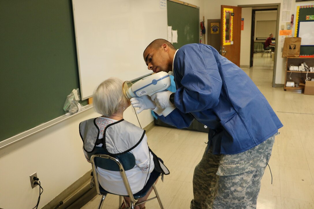 Spc. Eric Cooper, a dental technician with the 7234th Medical Support Unit out of Vallejo, Calif., takes x-rays in preparation for the dentist at the Healthy Cortland Innovative Readiness Training event in Homer, N.Y. Healthy Cortland is one of the IRT events that provide real-world training in a joint civil-military environment while delivering world-class medical care to the people of Cortland, N.Y., from July 15-24.