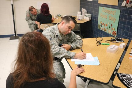 A1C Ryan Nelson, and Air Force Medic from 177th fighter wing in Atlantic City N.J., records a patient’s vital signs during the Healthy Cortland Innovative Readiness Training event, July 16, 2016.  Healthy Cortland is one of the IRT events that provide real-world training in a joint civil-military environment while delivering world-class medical care to the people of Cortland, N.Y., from July 15-24.