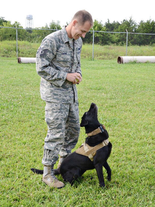 Tech. Sgt. James Swann, the 72nd Security Forces Squadron’s kennel master, plays with Military Working Dog Ritz, before a training session. Sergeant Swann’s responsibilities as kennel master include training and certification of the MWDs and handlers, among other duties, as well as being a handler to Ritz.