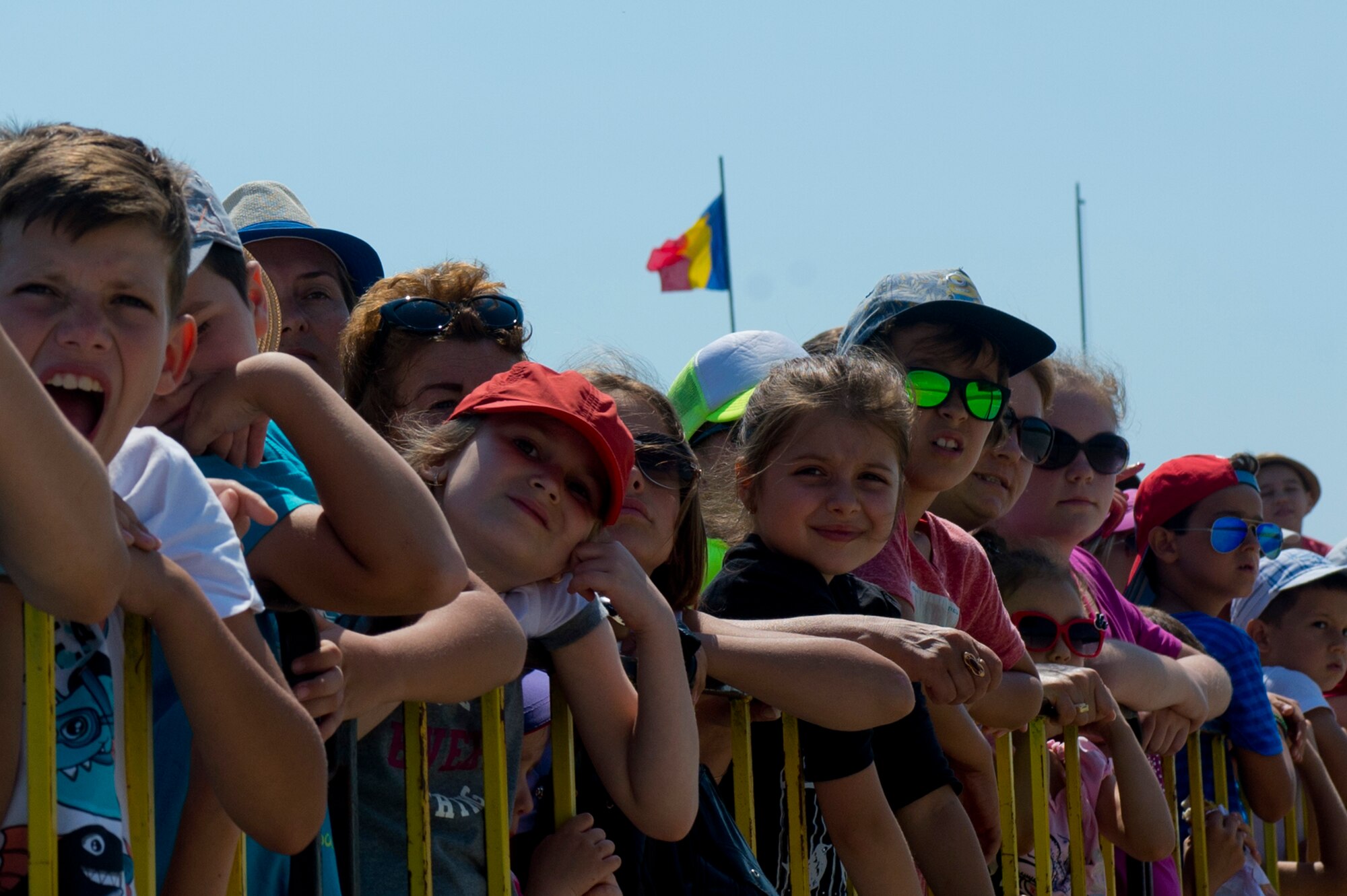 Romanian children watch aircraft take off from the flightline during the Romanian air force's 71st Air Base's air show and open house at Campia Turzii, Romania, July 23, 2016. The aviation demonstration took place during the middle of the U.S. Air Force's 194th Expeditionary Fighter Squadron's six-month long theater security package deployment to Europe in support of Operation Atlantic Resolve, which aims to bolster the U.S.'s continued commitment to the collective security of NATO and dedication to the enduring peace and stability in the region. The unit, comprised of more than 200 CANG Airmen from the 144th Fighter Wing at Fresno ANG Base, Calif., as well as U.S. Air Force Airmen from the 52nd Fighter Wing at Spangdahlem Air Base, Germany, piloted, maintained and supported the deployment of 12 F-15Cs Eagle fighter aircraft throughout nations like Romania, Iceland, the United Kingdom, the Netherlands, Estonia and among others. The F-15Cs took to the skies alongside the 71st AB's MiG-21 fighter aircraft and Puma helicopters for both the airshow, the second engagement of its kind at Campia Turzii under Operation Atlantic Resolve, and the bilateral flight training, also known as Dacian Eagle 2016. (U.S. Air Force photo by Staff Sgt. Joe W. McFadden/Released)

