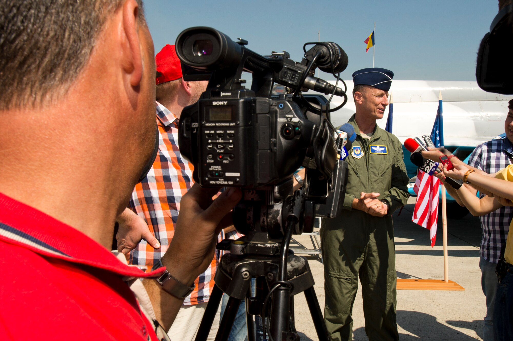 California Air National Guard Maj. Gen. Jon Kelk, both the ANG mobilization assistant to the U.S. Air Forces in Europe/Air Forces Africa commander and the commander, chief of staff of the CANG,answers reporters' questions during the Romanian air force's 71st Air Base's air show and open house at Campia Turzii, Romania, July 23, 2016. The aviation demonstration took place during the middle of the U.S. Air Force's 194th Expeditionary Fighter Squadron's six-month long theater security package deployment to Europe in support of Operation Atlantic Resolve, which aims to bolster the U.S.'s continued commitment to the collective security of NATO and dedication to the enduring peace and stability in the region. The unit, comprised of more than 200 CANG Airmen from the 144th Fighter Wing at Fresno ANG Base, Calif., as well as U.S. Air Force Airmen from the 52nd Fighter Wing at Spangdahlem Air Base, Germany, piloted, maintained and supported the deployment of 12 F-15Cs Eagle fighter aircraft throughout nations like Romania, Iceland, the United Kingdom, the Netherlands, Estonia and among others. The F-15Cs took to the skies alongside the 71st AB's MiG-21 fighter aircraft and Puma helicopters for both the airshow, the second engagement of its kind at Campia Turzii under Operation Atlantic Resolve, and the bilateral flight training, also known as Dacian Eagle 2016. (U.S. Air Force photo by Staff Sgt. Joe W. McFadden/Released)