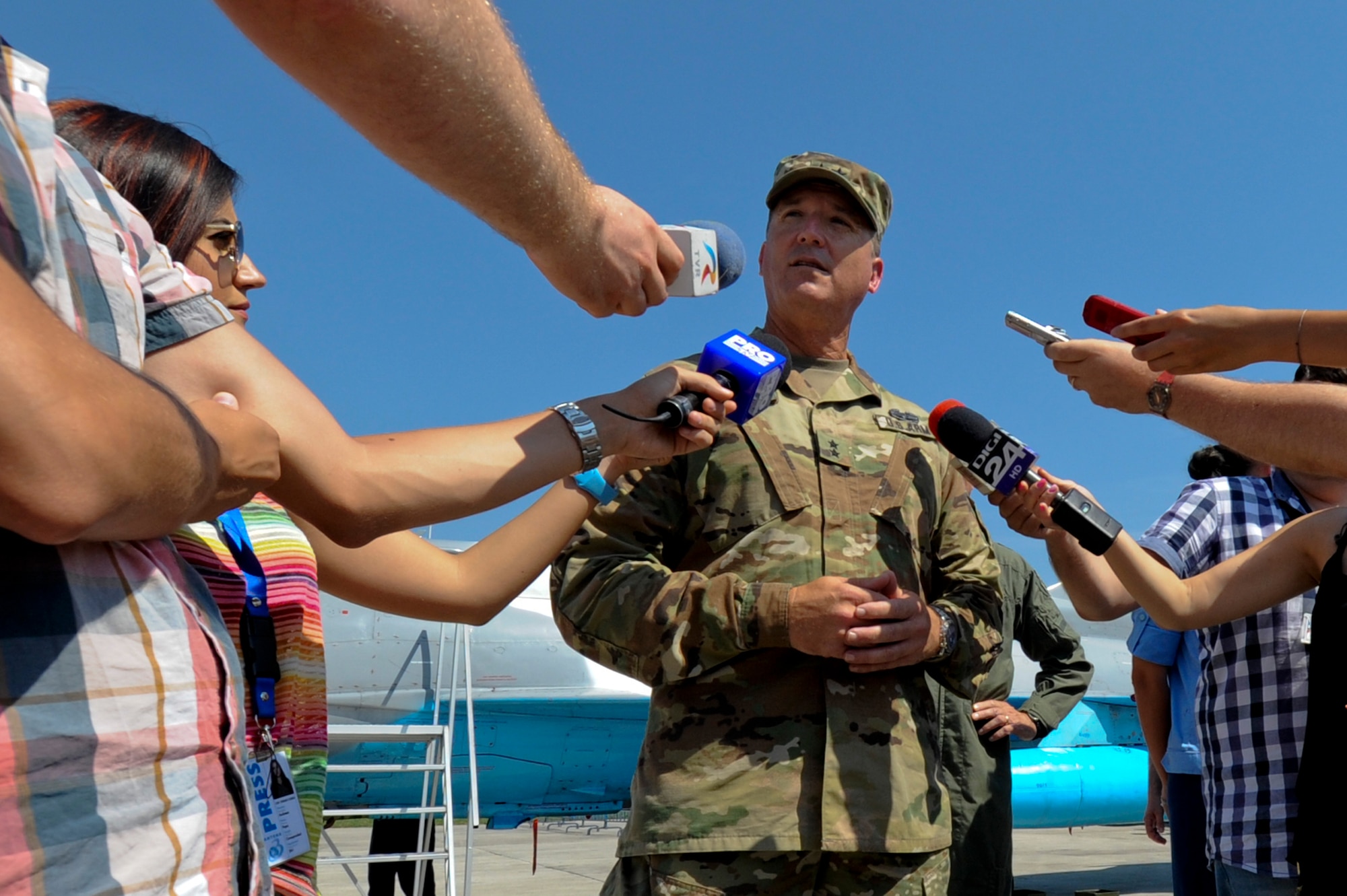 California Army National Guard Maj. Gen. Matthew Beevers, deputy adjutant general of the California Military Department, smiles answers reporters' questions during the Romanian air force's 71st Air Base's air show and open house at Campia Turzii, Romania, July 23, 2016. The aviation demonstration took place during the middle of the U.S. Air Force's 194th Expeditionary Fighter Squadron's six-month long theater security package deployment to Europe in support of Operation Atlantic Resolve, which aims to bolster the U.S.'s continued commitment to the collective security of NATO and dedication to the enduring peace and stability in the region. The unit, comprised of more than 200 CANG Airmen from the 144th Fighter Wing at Fresno ANG Base, Calif., as well as U.S. Air Force Airmen from the 52nd Fighter Wing at Spangdahlem Air Base, Germany, piloted, maintained and supported the deployment of 12 F-15Cs Eagle fighter aircraft throughout nations like Romania, Iceland, the United Kingdom, the Netherlands, Estonia and among others. The F-15Cs took to the skies alongside the 71st AB's MiG-21 fighter aircraft and Puma helicopters for both the airshow, the second engagement of its kind at Campia Turzii under Operation Atlantic Resolve, and the bilateral flight training, also known as Dacian Eagle 2016. (U.S. Air Force photo by Staff Sgt. Joe W. McFadden/Released)